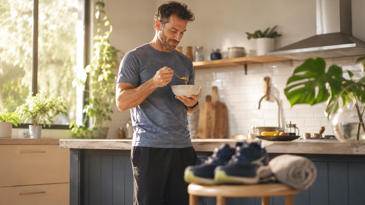 Man having breakfast at home, illustrating basal metabolism and daily activity